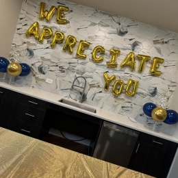 sign of balloons on a wall for resident party