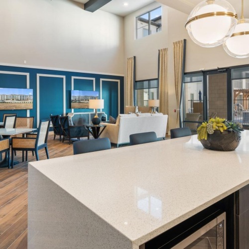 a spacious room with a large island and chairs