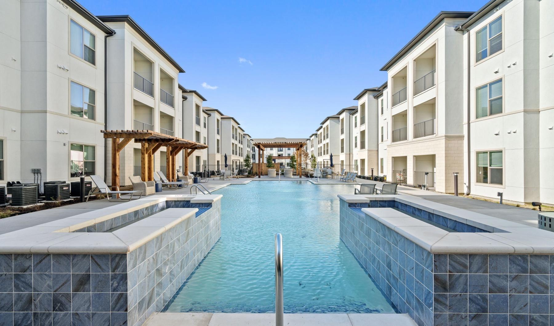 Resort-style swimming pool with lounge seating