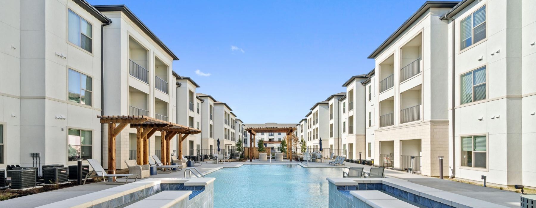 Resort-style swimming pool with lounge seating