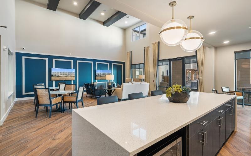 a spacious room with a large island and chairs