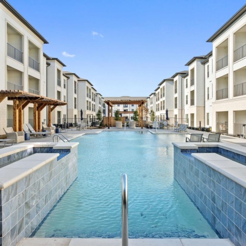 Resort-style swimming pool with lounge seating