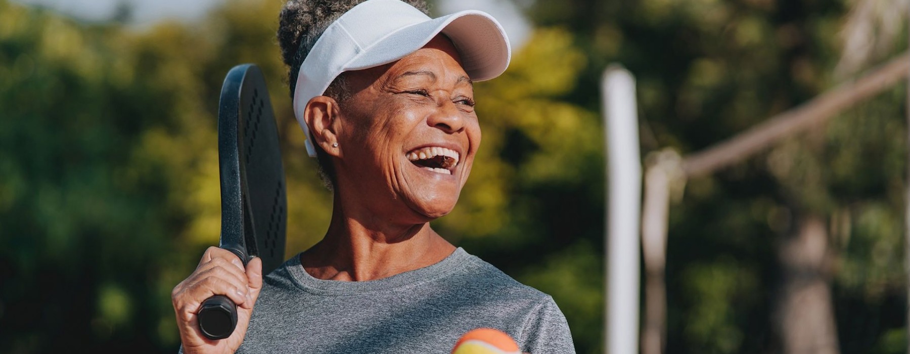 a woman playing pickleball