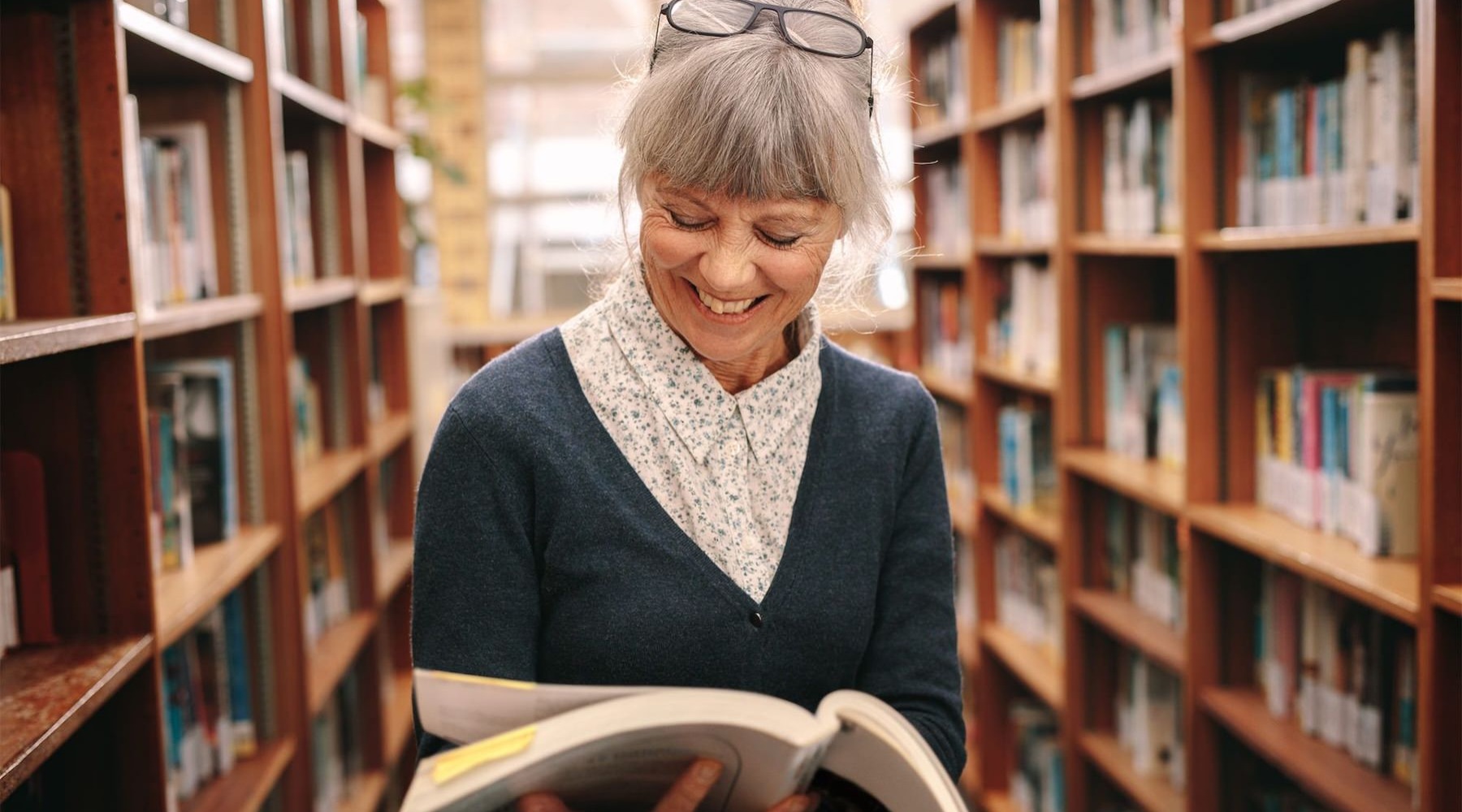 a woman reading in a library