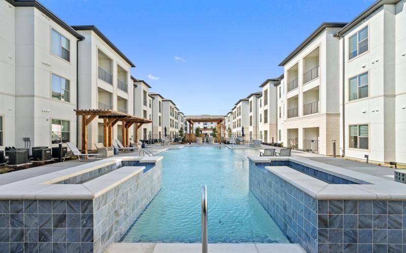 Resort-style swimming pool with lounge seating
